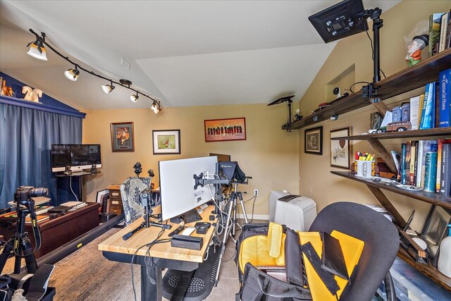 interior space featuring vaulted ceiling and track lighting