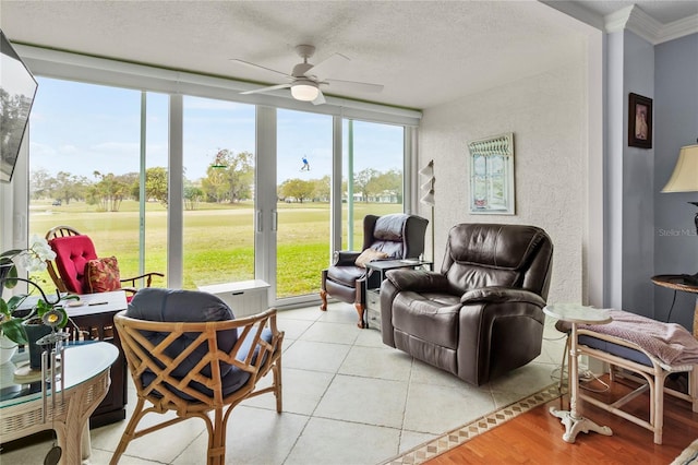 sunroom / solarium with a wealth of natural light and ceiling fan