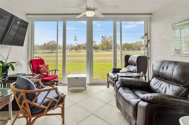 sunroom featuring ceiling fan and a wealth of natural light