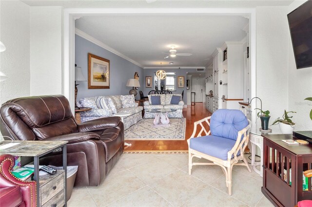 living room featuring light tile patterned floors and crown molding