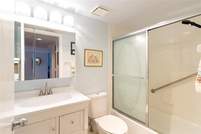 full bathroom featuring shower / bath combination with glass door, vanity, and toilet