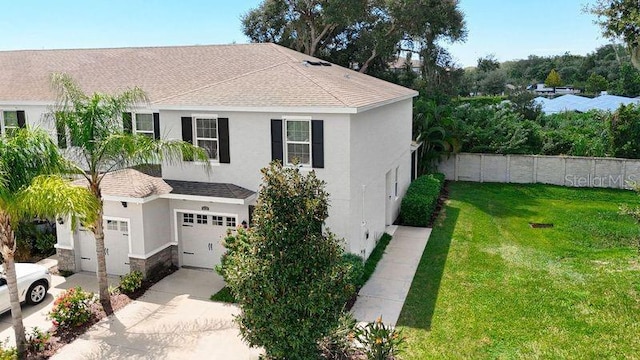 view of front of house featuring a garage and a front lawn