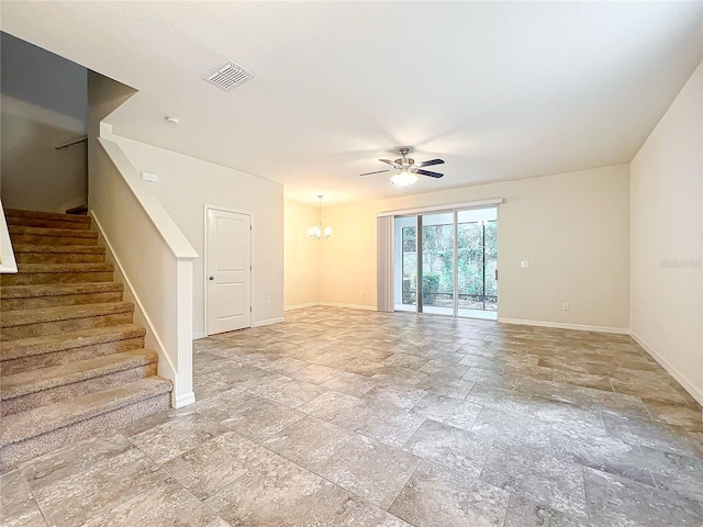 unfurnished living room with ceiling fan with notable chandelier, visible vents, stairs, and baseboards