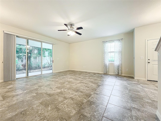 spare room with ceiling fan and a healthy amount of sunlight