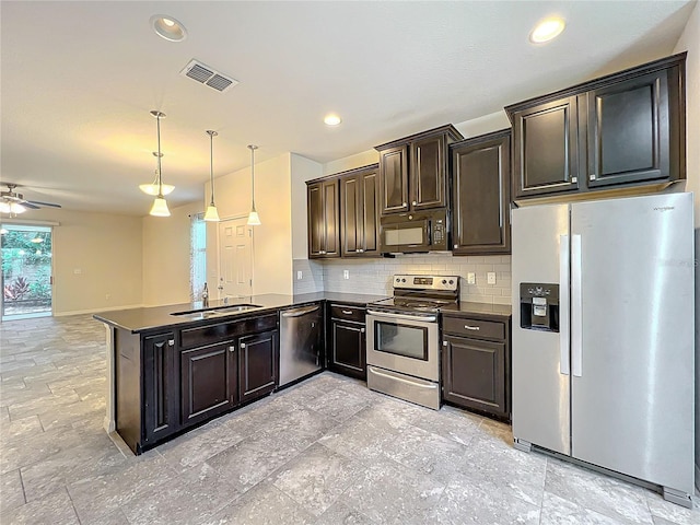 kitchen featuring ceiling fan, kitchen peninsula, decorative light fixtures, stainless steel appliances, and decorative backsplash