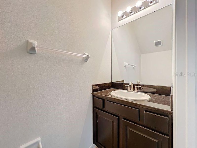 bathroom featuring visible vents and vanity