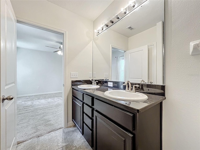 full bath with visible vents, ceiling fan, a sink, and double vanity