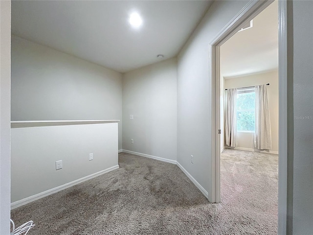 unfurnished room featuring baseboards and carpet