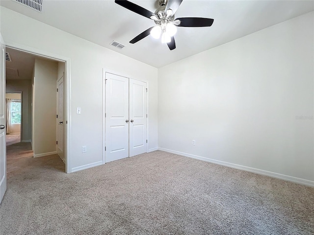 unfurnished bedroom with carpet, baseboards, and visible vents