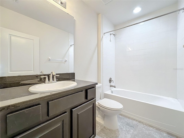 full bathroom featuring vanity, tiled shower / bath combo, and toilet