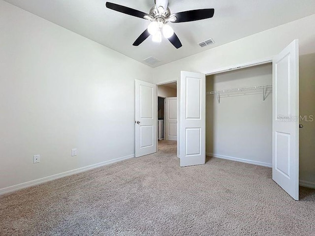 unfurnished bedroom with light carpet, ceiling fan, and a closet