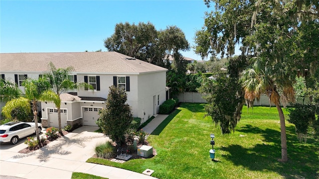 view of front of home with a garage and a front lawn