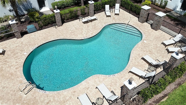 pool with fence and a patio area