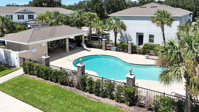 community pool featuring a patio and fence