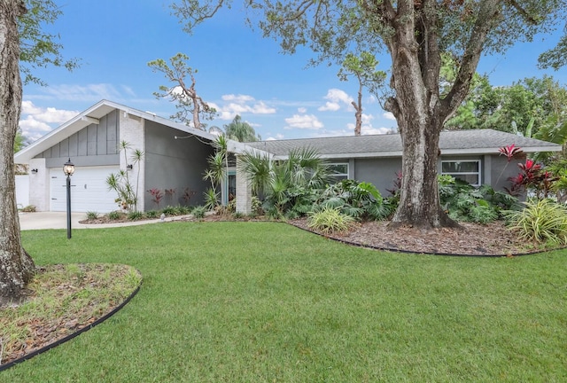 ranch-style house featuring a garage and a front lawn