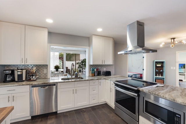 kitchen featuring white cabinetry, backsplash, stainless steel appliances, dark wood-type flooring, and extractor fan