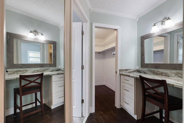 bathroom featuring a textured ceiling, ornamental molding, and hardwood / wood-style flooring