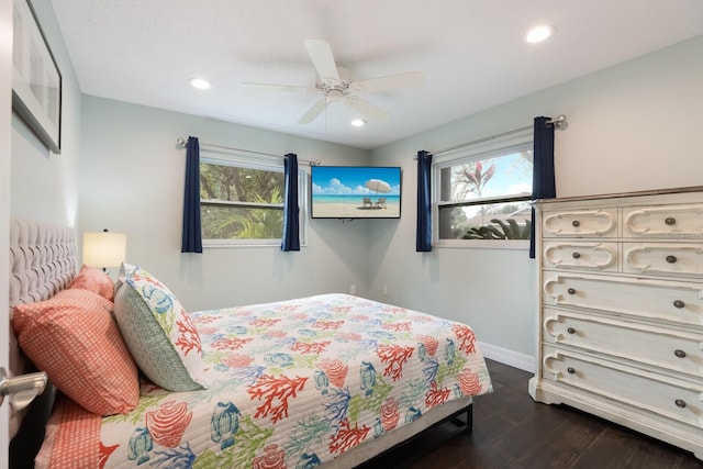 bedroom with multiple windows, ceiling fan, and dark hardwood / wood-style floors