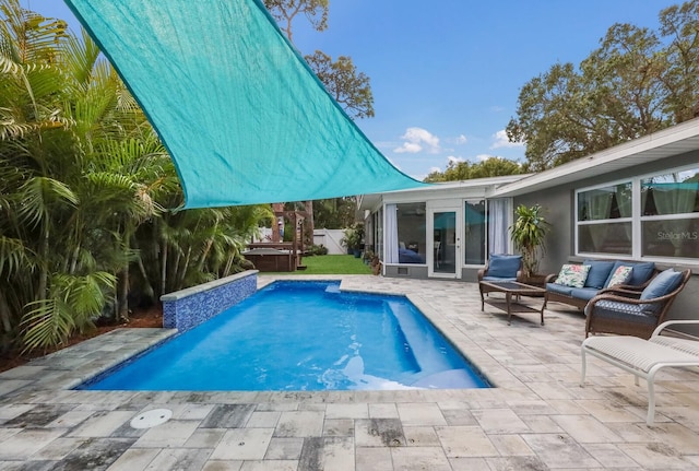 view of swimming pool featuring french doors, an outdoor living space, a jacuzzi, and a patio