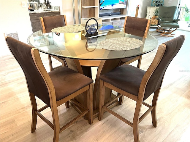 dining space with light wood-style flooring