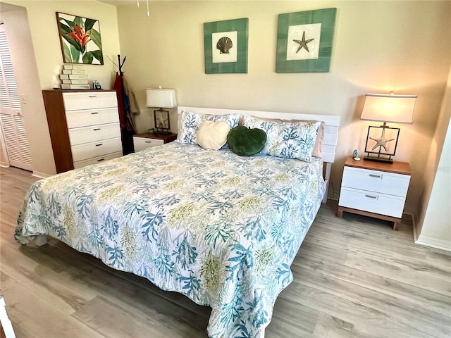 bedroom featuring baseboards and wood finished floors