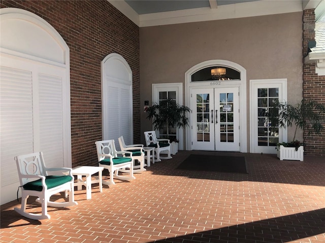 doorway to property featuring french doors and stucco siding