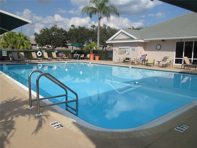 pool featuring a patio area and fence