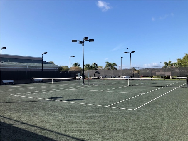 view of sport court featuring fence