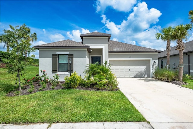 view of front of home with a garage and a front lawn