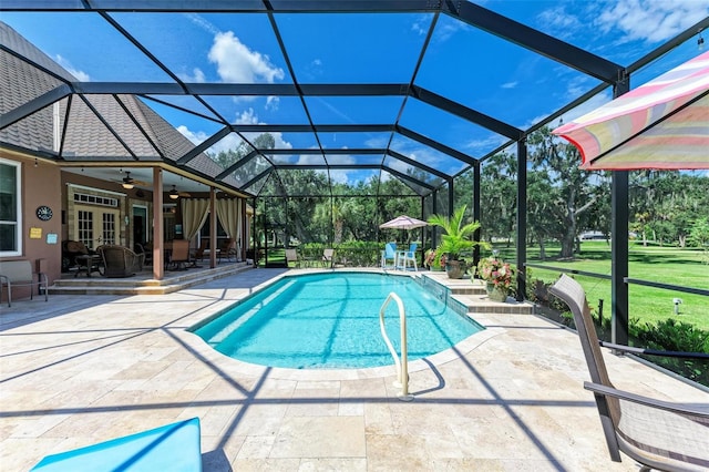 view of swimming pool with a lanai, ceiling fan, and a patio