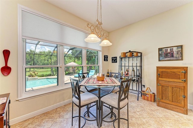 tiled dining space featuring a healthy amount of sunlight