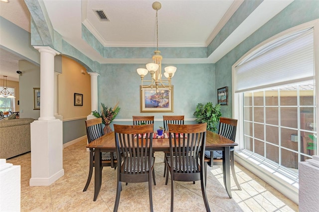 dining room with decorative columns, ornamental molding, and a notable chandelier