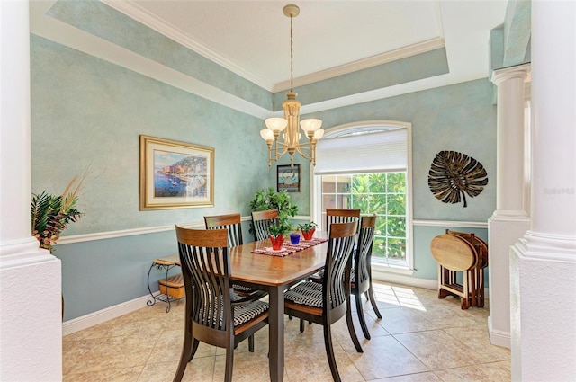 tiled dining area with crown molding, an inviting chandelier, and ornate columns