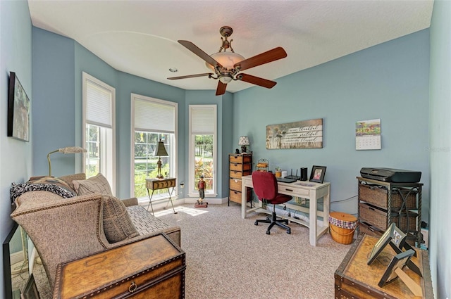 carpeted home office with ceiling fan