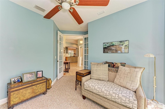 living room with ceiling fan, carpet floors, and french doors