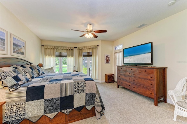 bedroom featuring ceiling fan, access to exterior, and light carpet