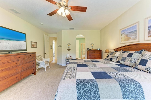 bedroom with light carpet, a textured ceiling, and ceiling fan