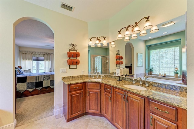 bathroom with tile patterned floors, independent shower and bath, vanity, ceiling fan, and a textured ceiling