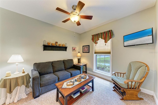 carpeted living room with ceiling fan