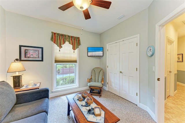 carpeted living room with ceiling fan