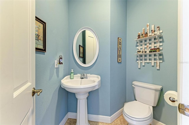 bathroom featuring toilet and tile patterned floors