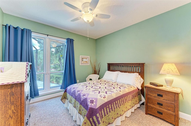 bedroom featuring multiple windows, ceiling fan, and carpet floors