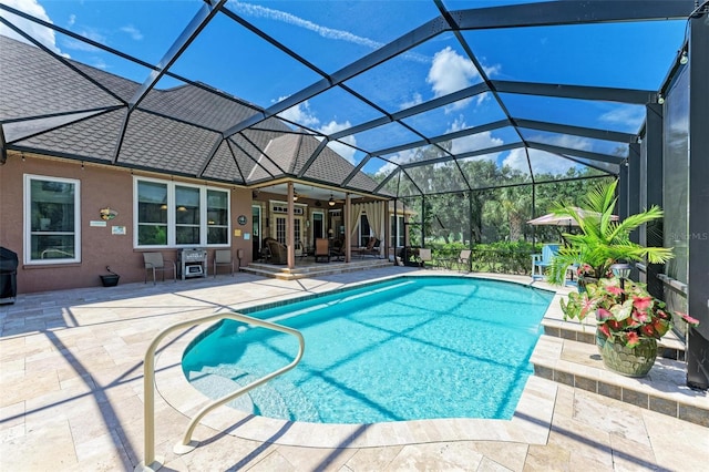 view of swimming pool featuring a lanai and a patio area