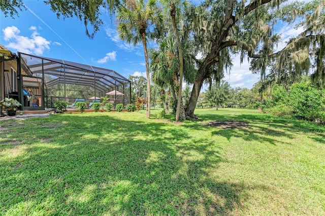 view of yard featuring glass enclosure