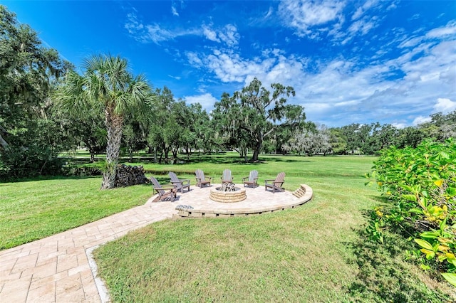 view of yard with a patio and an outdoor fire pit