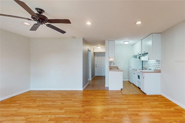 kitchen featuring light wood-type flooring, white cabinetry, and ceiling fan