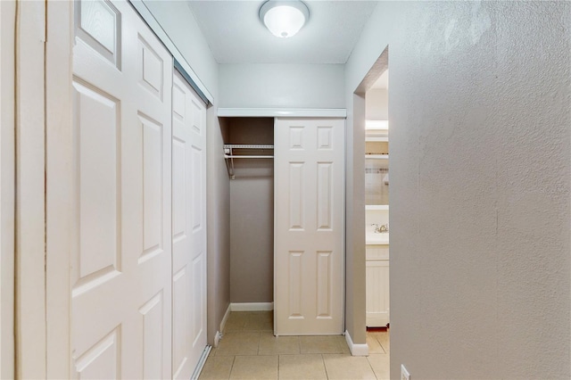 hallway featuring light tile patterned floors