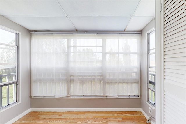 unfurnished sunroom with a paneled ceiling