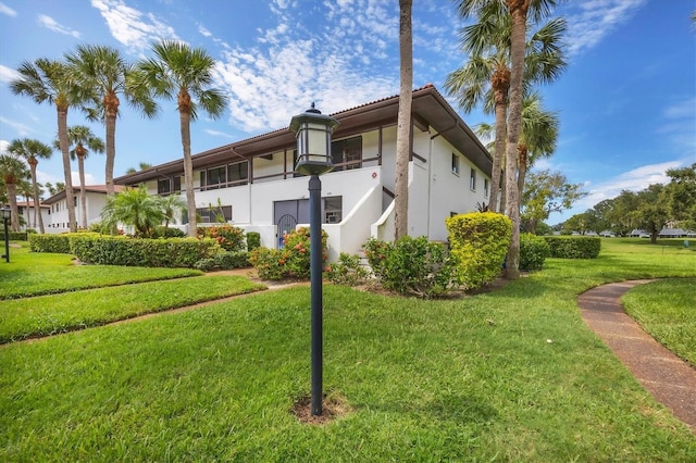 view of property exterior with a lawn