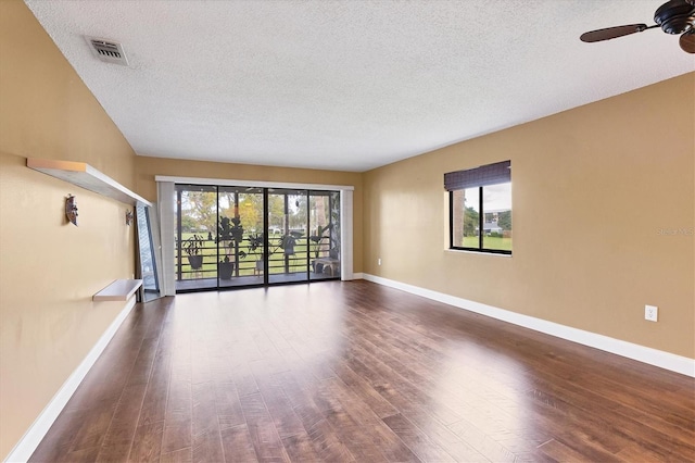 unfurnished room featuring dark hardwood / wood-style flooring, plenty of natural light, and ceiling fan